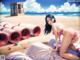 A woman in a pink bikini laying on a beach.