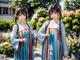 A couple of women standing next to each other in a garden.