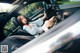 A woman sitting in the driver's seat of a car.